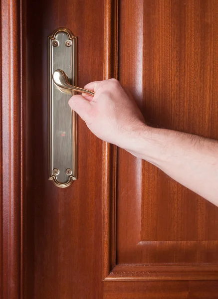 Hand gripping the handle of a door — Stock Photo, Image