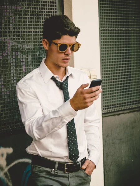 Casual businessman looking his smartphone — Stock Photo, Image