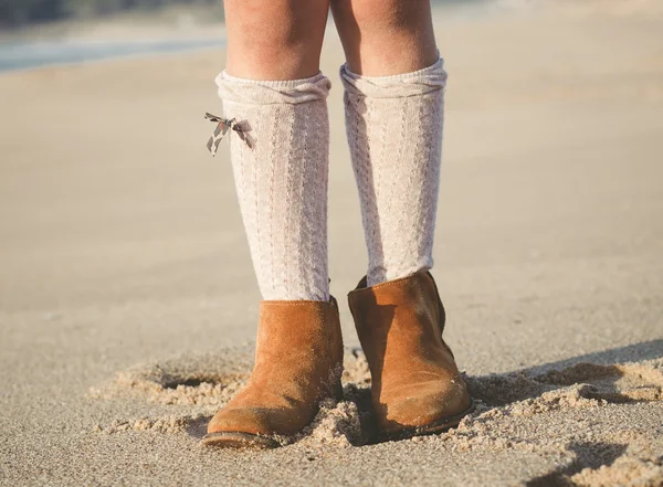 Detail of little girl boots on the beach — Stock Photo, Image