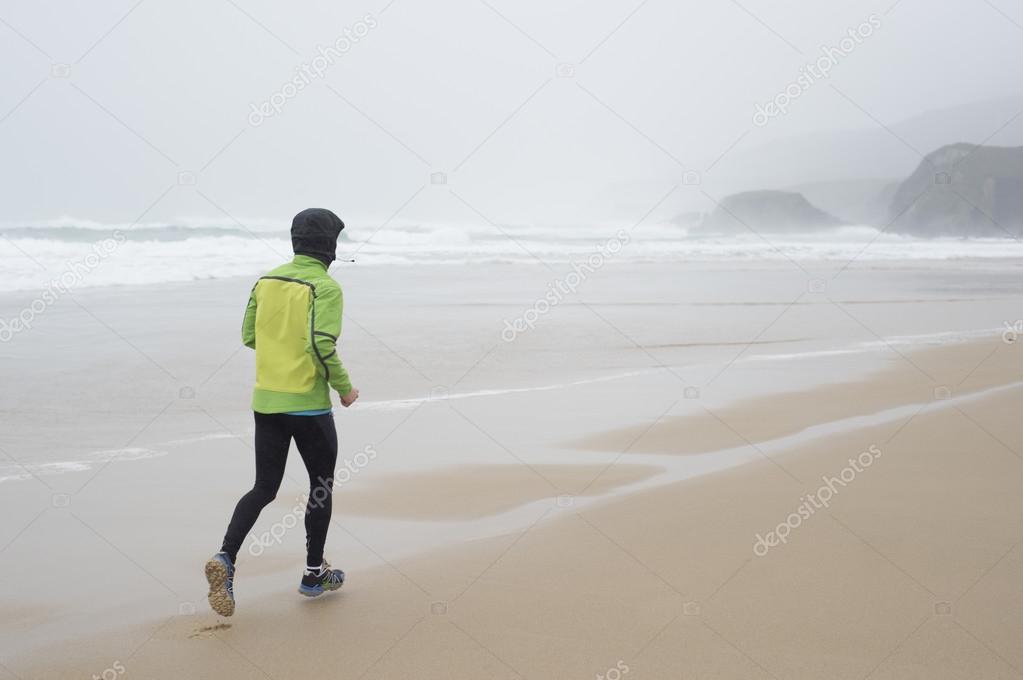 Runner man running on the beach