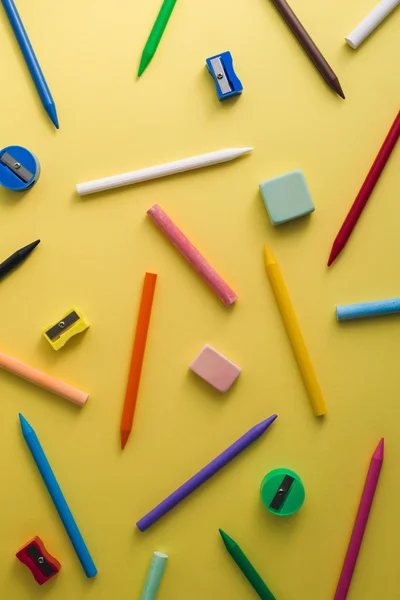 Crayons, pencil sharpeners, erasers and chalks of different colo — Stock Photo, Image
