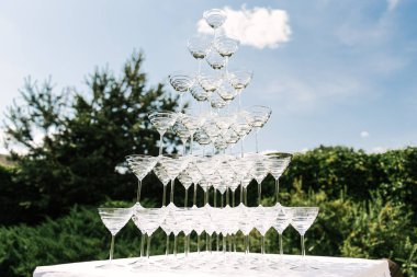 Piramit şeklinde bir sürü şampanya, açık havada bir büfe.