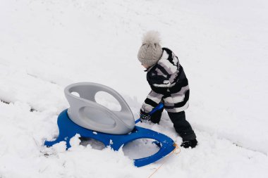 Kar kızağındaki tatlı çocuk, aktif yaşam tarzı, kış, aile.