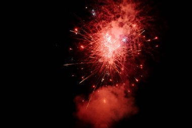 Siyah gökyüzünde renkli gece patlamaları. Gece gökyüzünde çok renkli güzel havai fişekler. Yeni yıl arifesi havai fişek kutlaması. Gece gökyüzünde havai fişek gibi parlayan ışıklar. Parlayan havai fişek gösterisi.