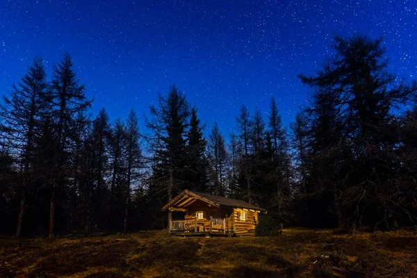 Log house in the forest, night scene with stars, Gleinser Berg, Tyrol, Austria, Europe