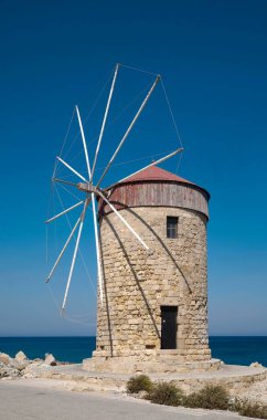 Windmills at Mandraki Harbour, Rhodes Town, Rhodes, Dodecanese, Greece, Europe clipart