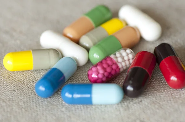 Assortment of capsules on fabric — Stock Photo, Image