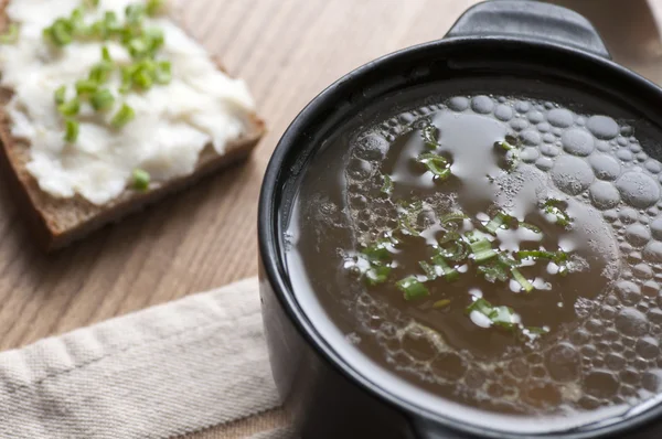 Mushroom soup served with lard spread with green onion — Stock Photo, Image