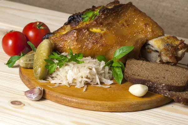 Roasted pork leg served with sauerkraut — Stock Photo, Image