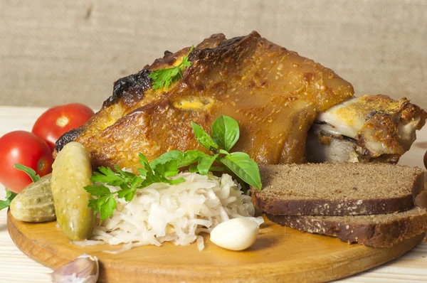 Roasted pork leg served with sauerkraut — Stock Photo, Image