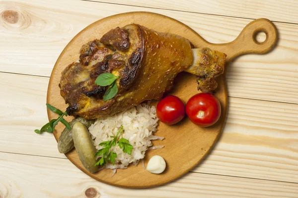 Roasted pork leg served with sauerkraut — Stock Photo, Image