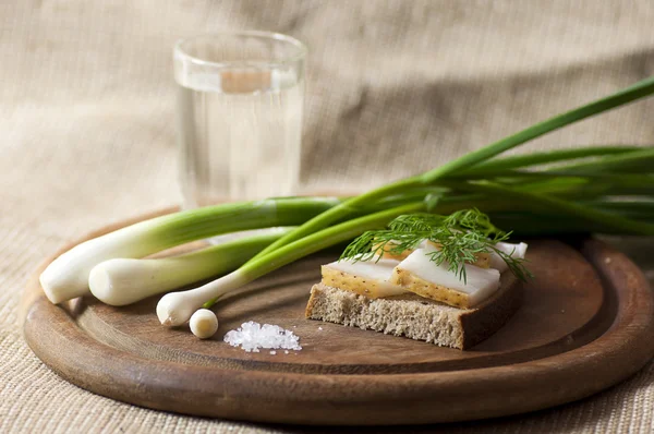 Sandwich with salted lard on rye bread and vodka — Stock Photo, Image