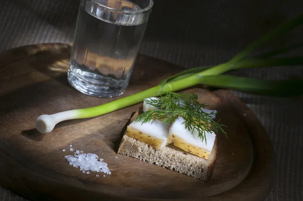 Sandwich with salted lard on rye bread and vodka — Stock Photo, Image
