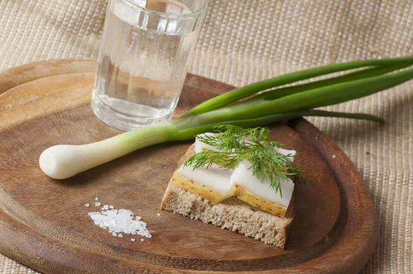 Sandwich with salted lard on rye bread and vodka — Stock Photo, Image