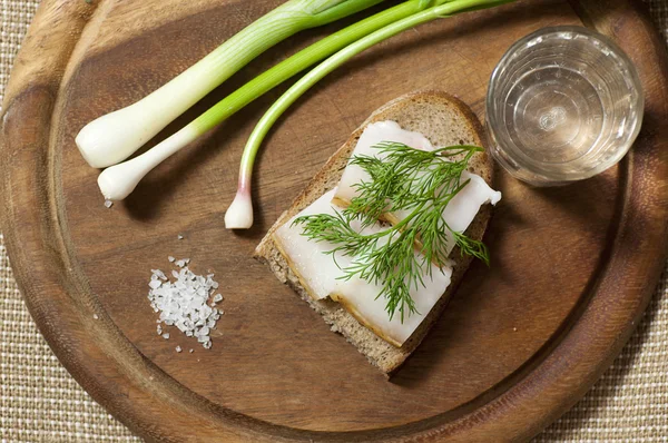 Sandwich with salted lard on rye bread and vodka — Stock Photo, Image