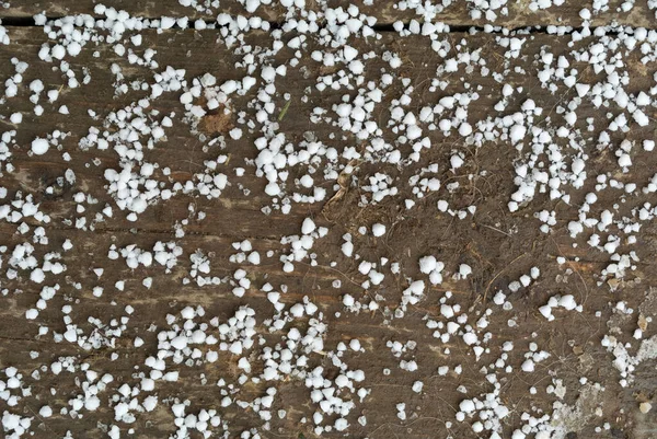 Small White Snow Flakes First Snow Dirty Wooden Floor Close — стоковое фото