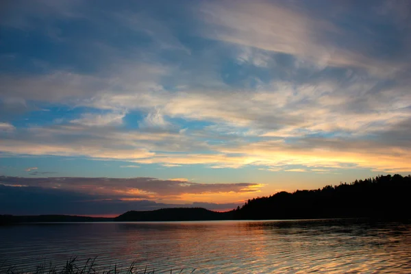 Lago de noche bajo la luz del atardecer —  Fotos de Stock