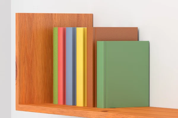 Colored books on wooden bookshelf on white wall — Stock Photo, Image