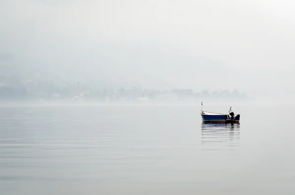 Barco en un lago con aire brumoso — Foto de Stock