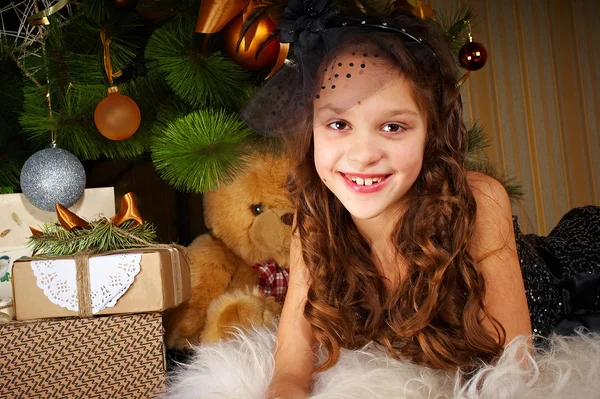 Laughing girl on a background of the Christmas tree — Stock Photo, Image