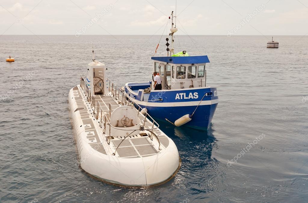 Atlantis Submarine and Atlas tugboat in Grand Cayman Stock Editorial