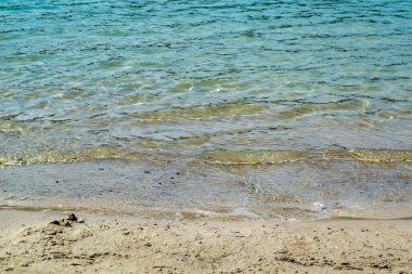 Gök mavisi. Temiz su. Yaz plajı gün ışığında.