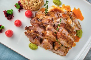 Soslu ızgara biftek ve ahşap masada bulgur pilavı..