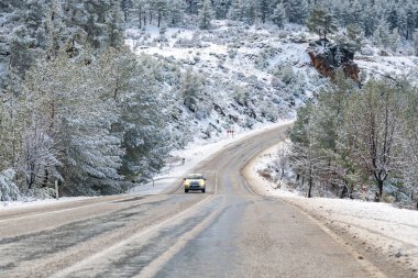 Karla kaplı ormanın manzaralı yolu..