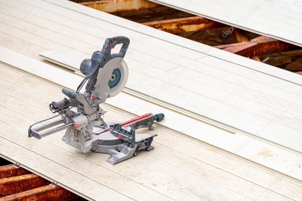 circular saws standing on the assembled composite Deck