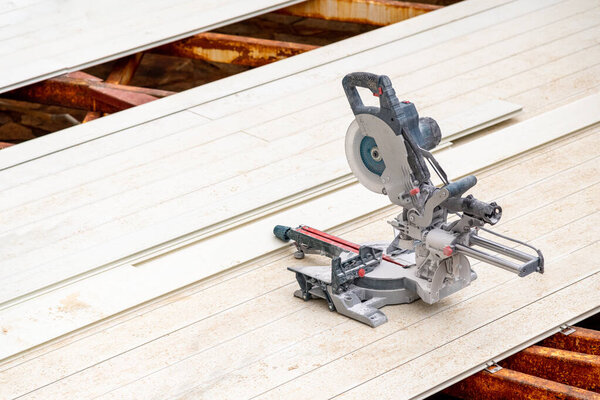 circular saws standing on the assembled composite Deck