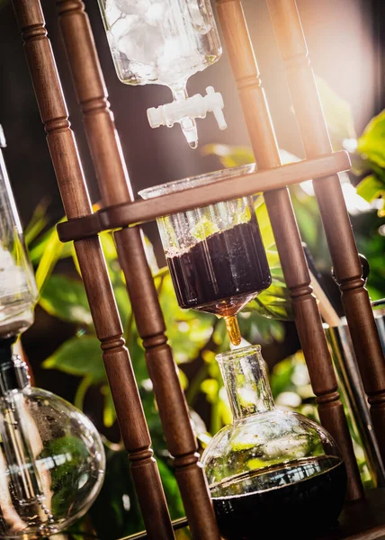 cold drip coffee tower with soft-focus and over light in the background