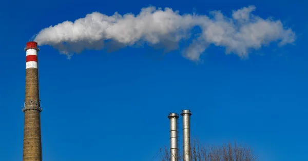 Chimney smoke. Pipe emits long trail of smoke