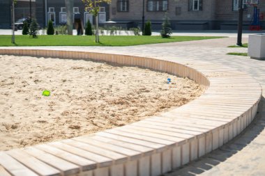 Sokaktaki umumi alanda kum havuzu, çocuklar için aktiviteleri olan kasaba parkı.