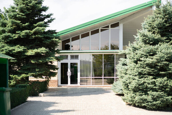 the small modern countryside house yard with large windows, outdoor summer season