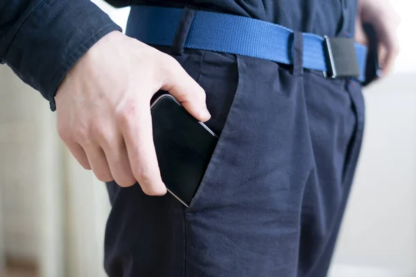 A cleptomania concept, man criminal stealing things and put them into pocket — Stock Photo, Image