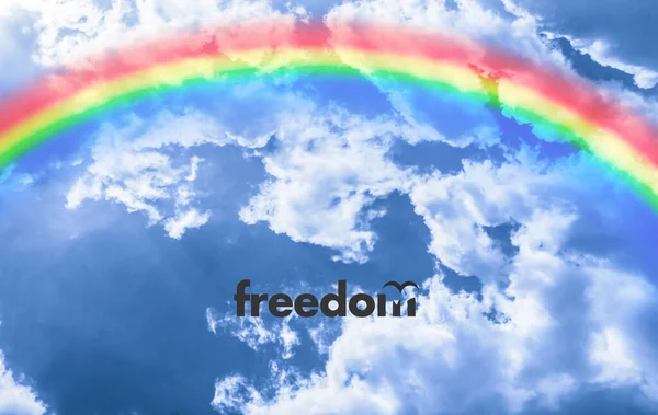 Rainbow in the sky clouds with the motivationaltext, feel the freedom and happy life — Stock Photo, Image