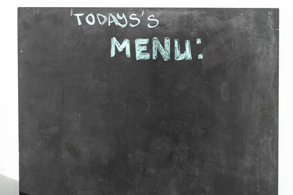 A black chalkboard with menu text in the street restaurant — Stockfoto