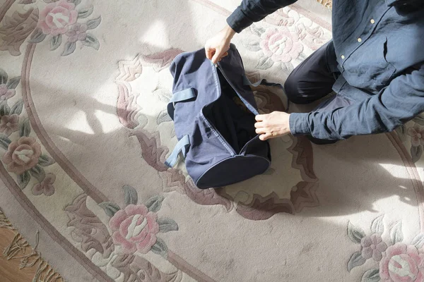 A overhead view of person packing things in the bag before travel journey start — Stock Photo, Image