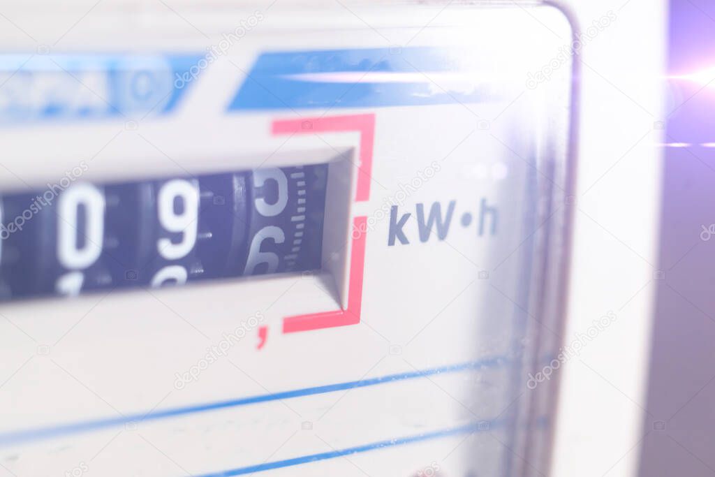 a macro view of electricity watt meter, kilowatt calculator counter at home, savings economy