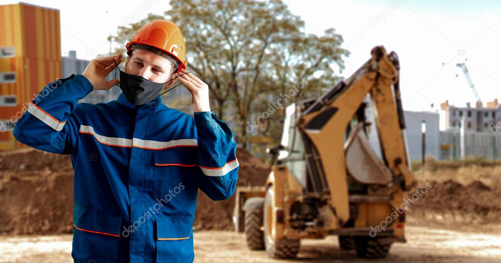 a worker in the uniform wearing a protective mask while doing job. protect from coronavirus