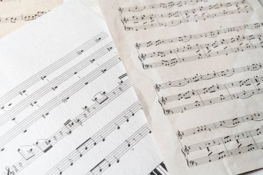 Müzik notaları ve klasik kültür sanatları içeren eski bir kağıt kapağı.