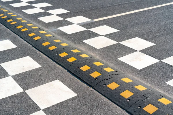 A speed bump on the city road. asphalt barrier, safety obstacle — 스톡 사진