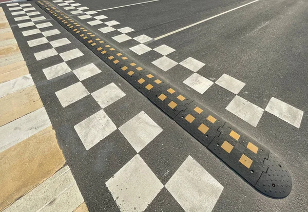 A speed bump on the city road. asphalt barrier, safety obstacle — 스톡 사진