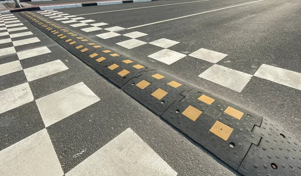 A speed bump on the city road. asphalt barrier, safety obstacle — 스톡 사진