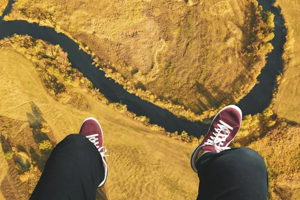 a high above top down view, the legs on frame and watching the landscape view