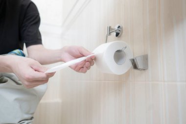 Tuvalet kağıdı alan yakın bir insan eli.