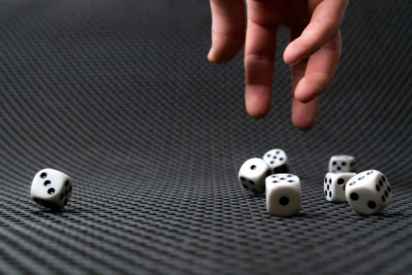 A persons hand roll the dice cubes on the table, win gamble casino — 图库照片