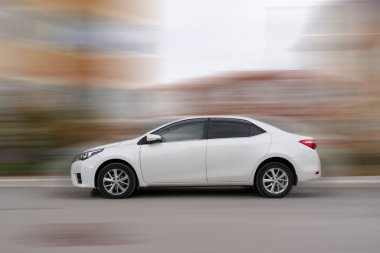 Şehirde hızla ilerleyen modern bir araba, hareket bulanık şehir konsepti