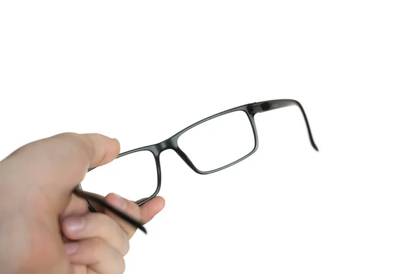 A isolated on white persons hand holding a eyeglasses, mockup design, optical frame — Stock Photo, Image