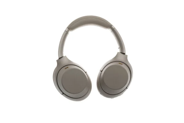 A new modern gray wireless headphones, audio studio device isolated — Stockfoto